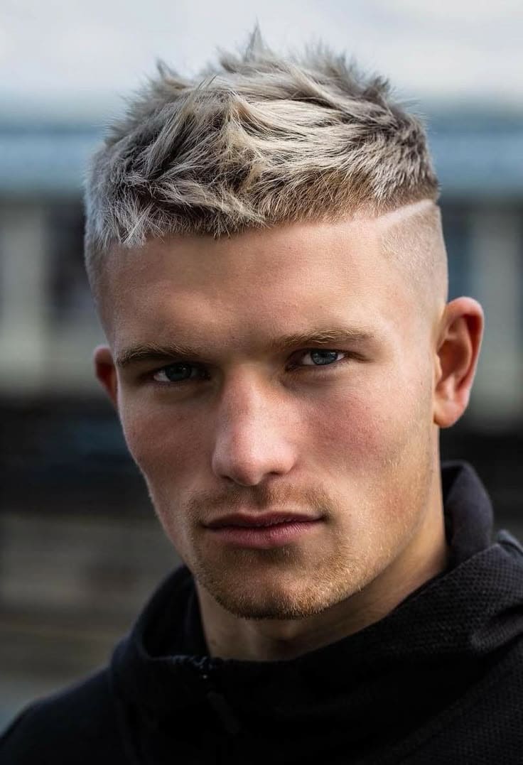 Spiky crop haircut for men with piecey texture and skin fade